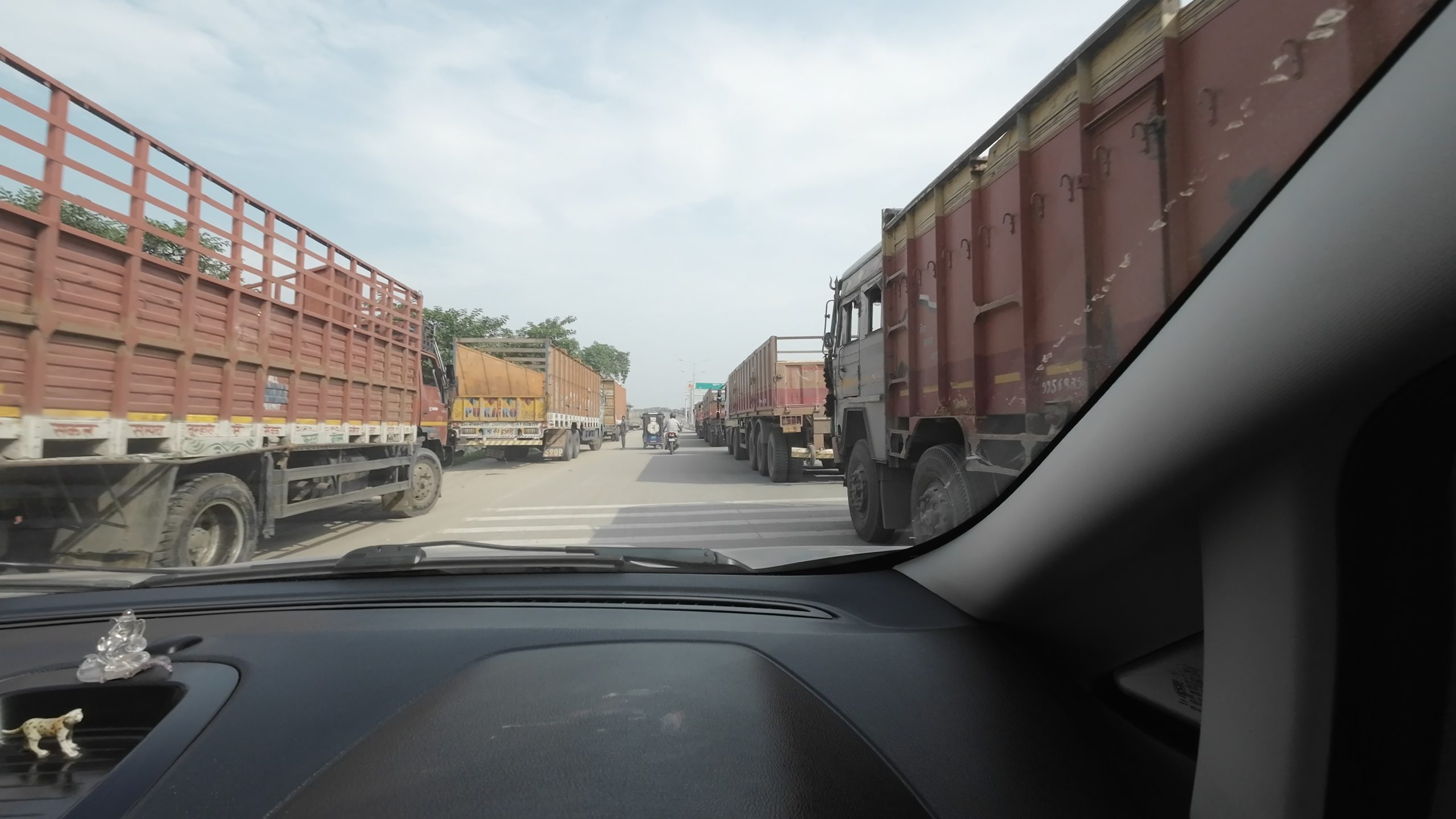 A massive, mile-long traffic jam of heavy commercial cargo trucks waiting at the Bihar and Uttar Pradesh border crossing near Buxar