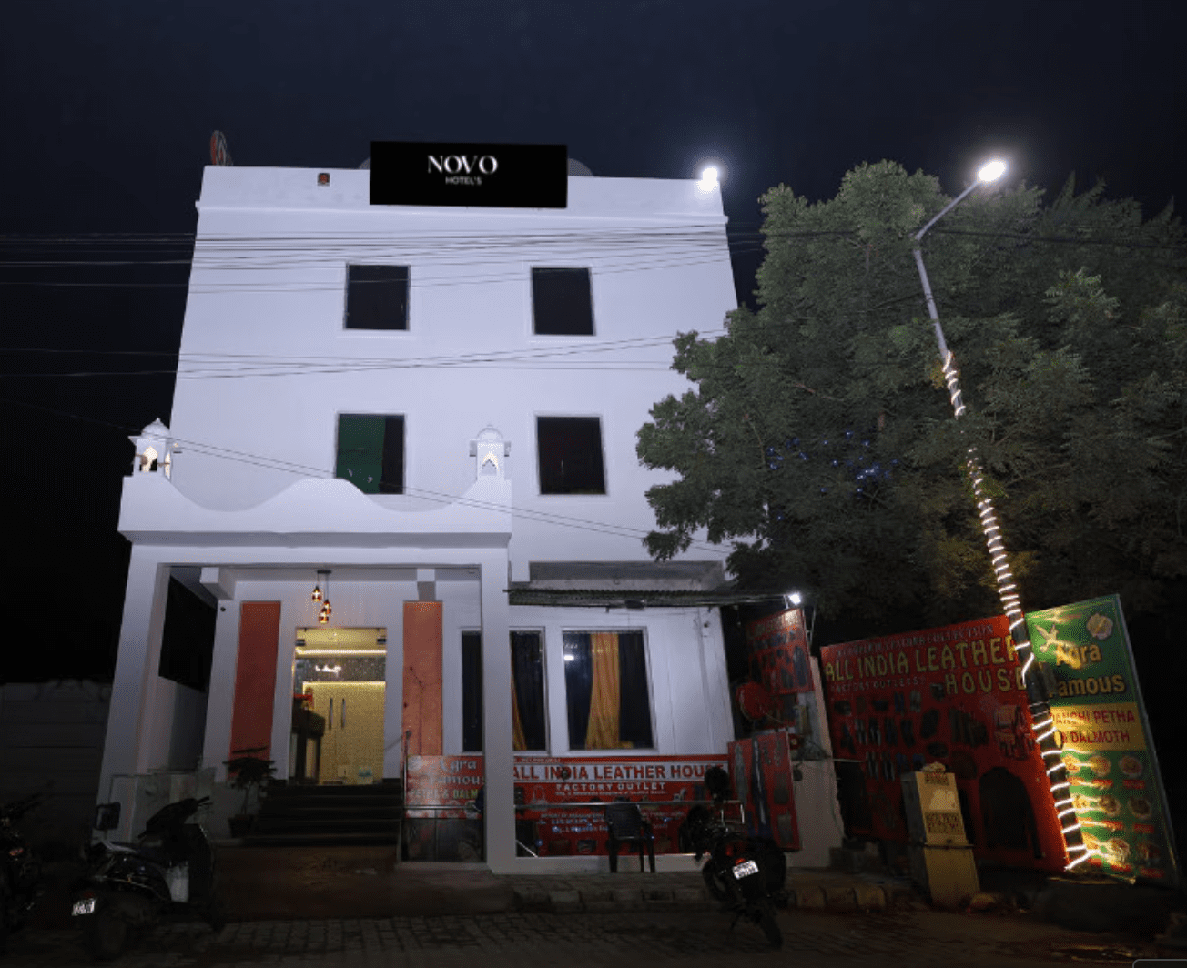 Exterior view and secure parking lot of Hotel Novo Agra, a budget-friendly stay near the Taj Mahal Eastern Gate
