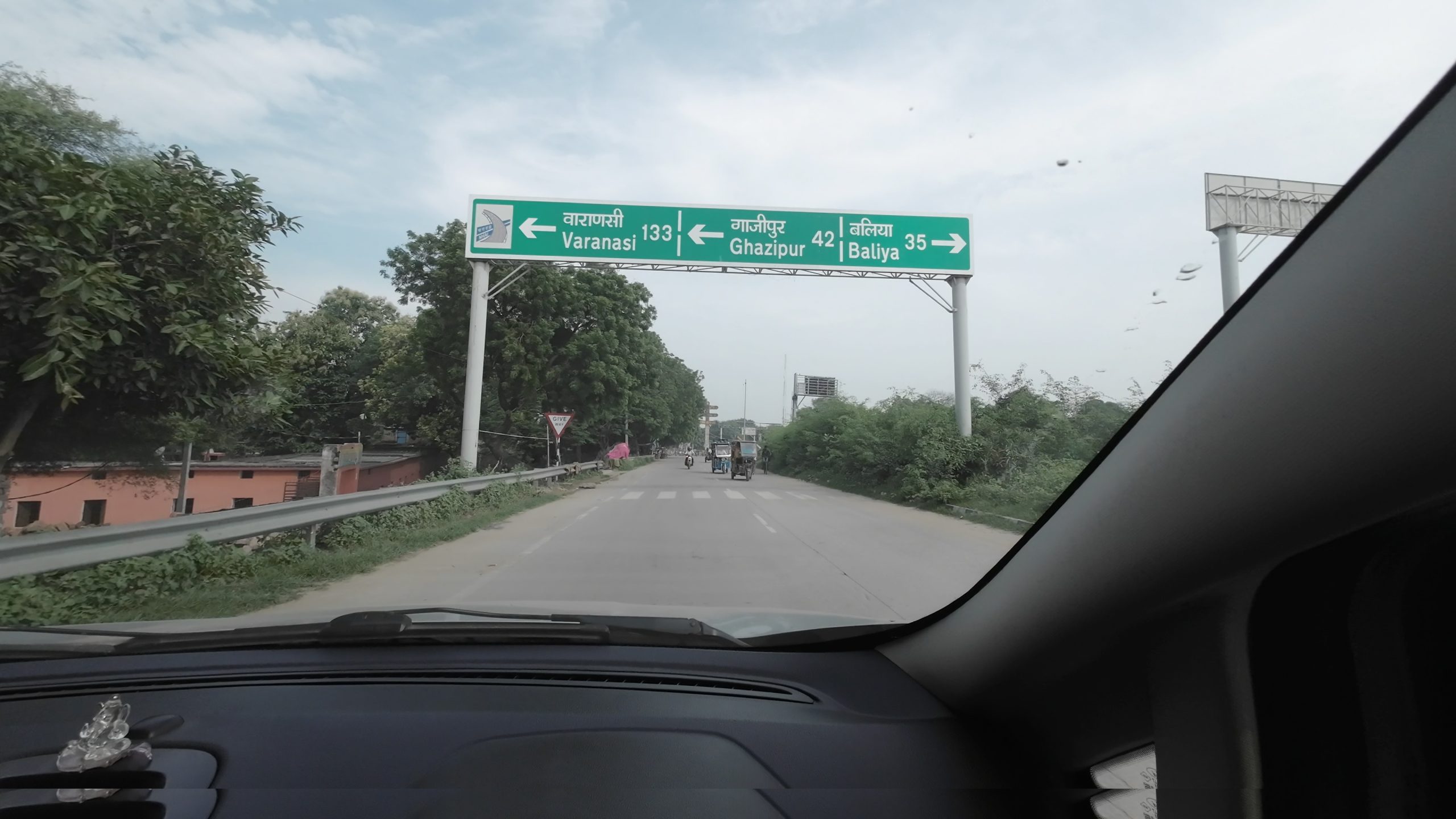 A bright blue highway signboard reading Uttar Pradesh Welcomes You, marking the state border crossing from Bihar