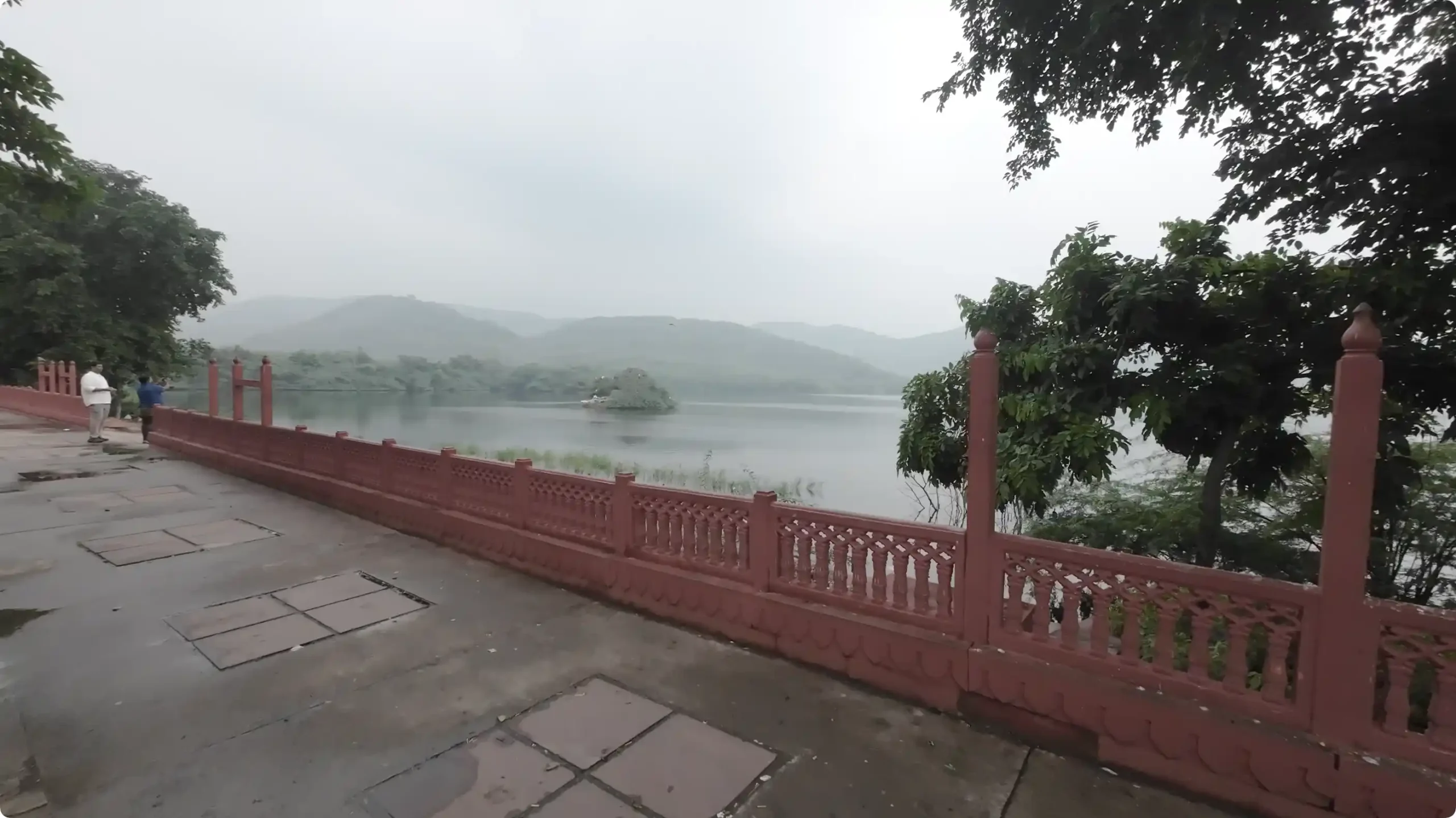A peaceful view of the backside of the Jal Mahal palace floating on the calm waters of Man Sagar Lake in Jaipur